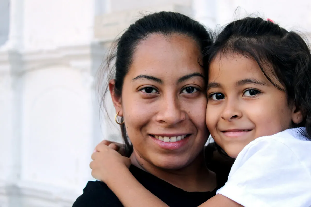 A smiling mother and daughter