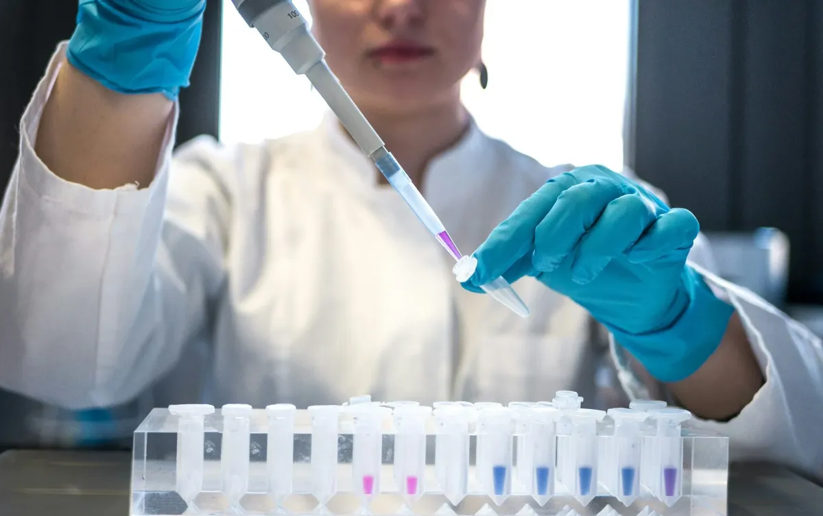 A scientist using a pipette
