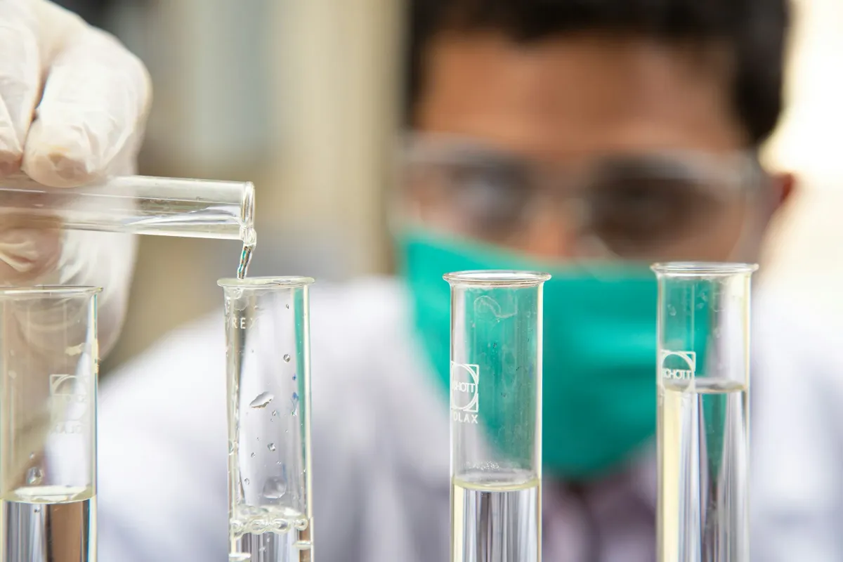 A scientist pouring liquid into a test tube