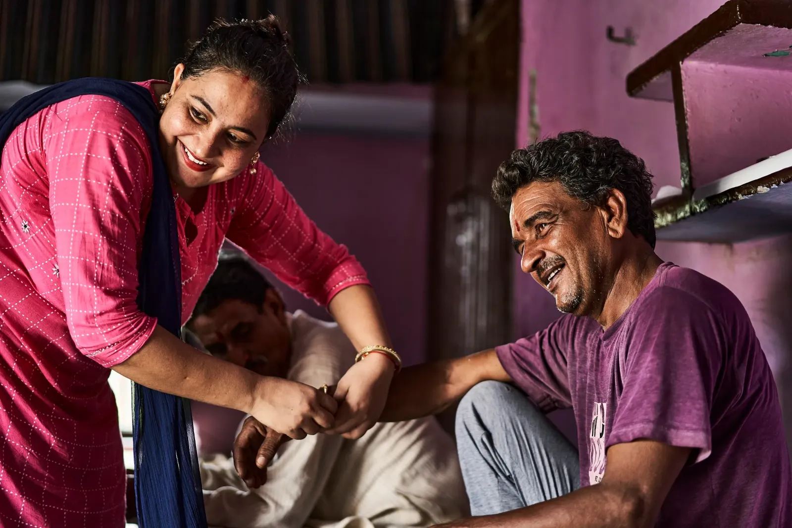 A health worker with an older man