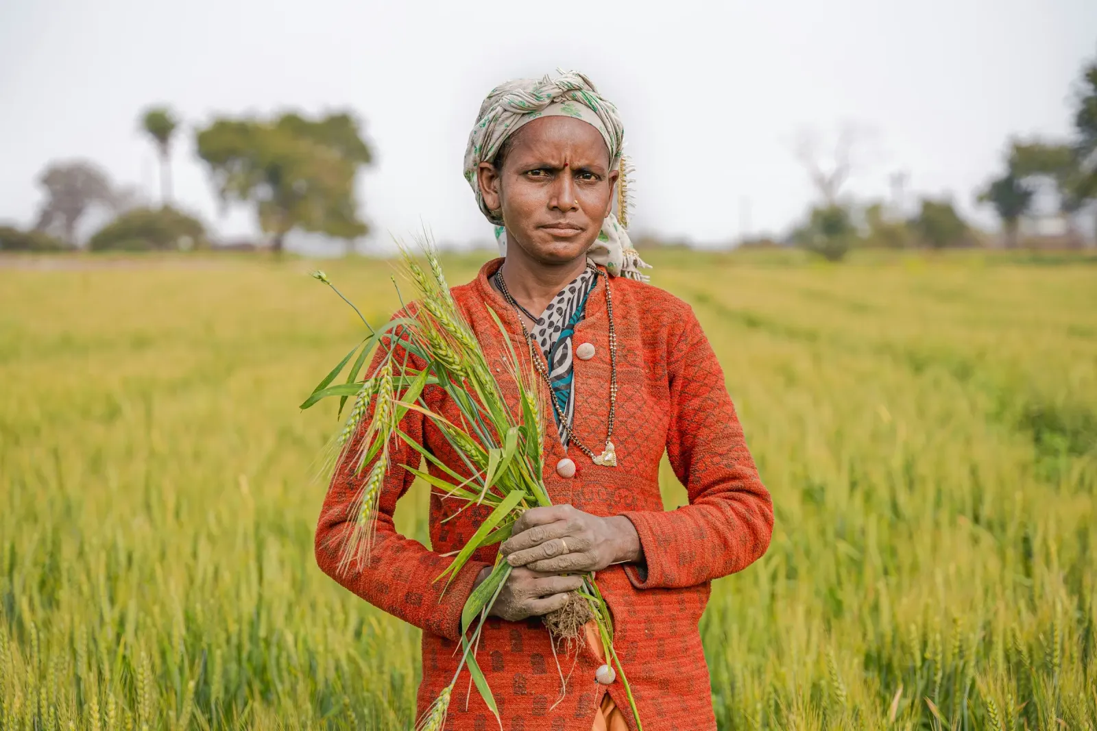 A woman standing in a green field