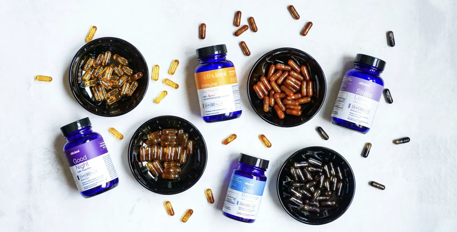 Supplement bottles with bowls of capsules and softgels