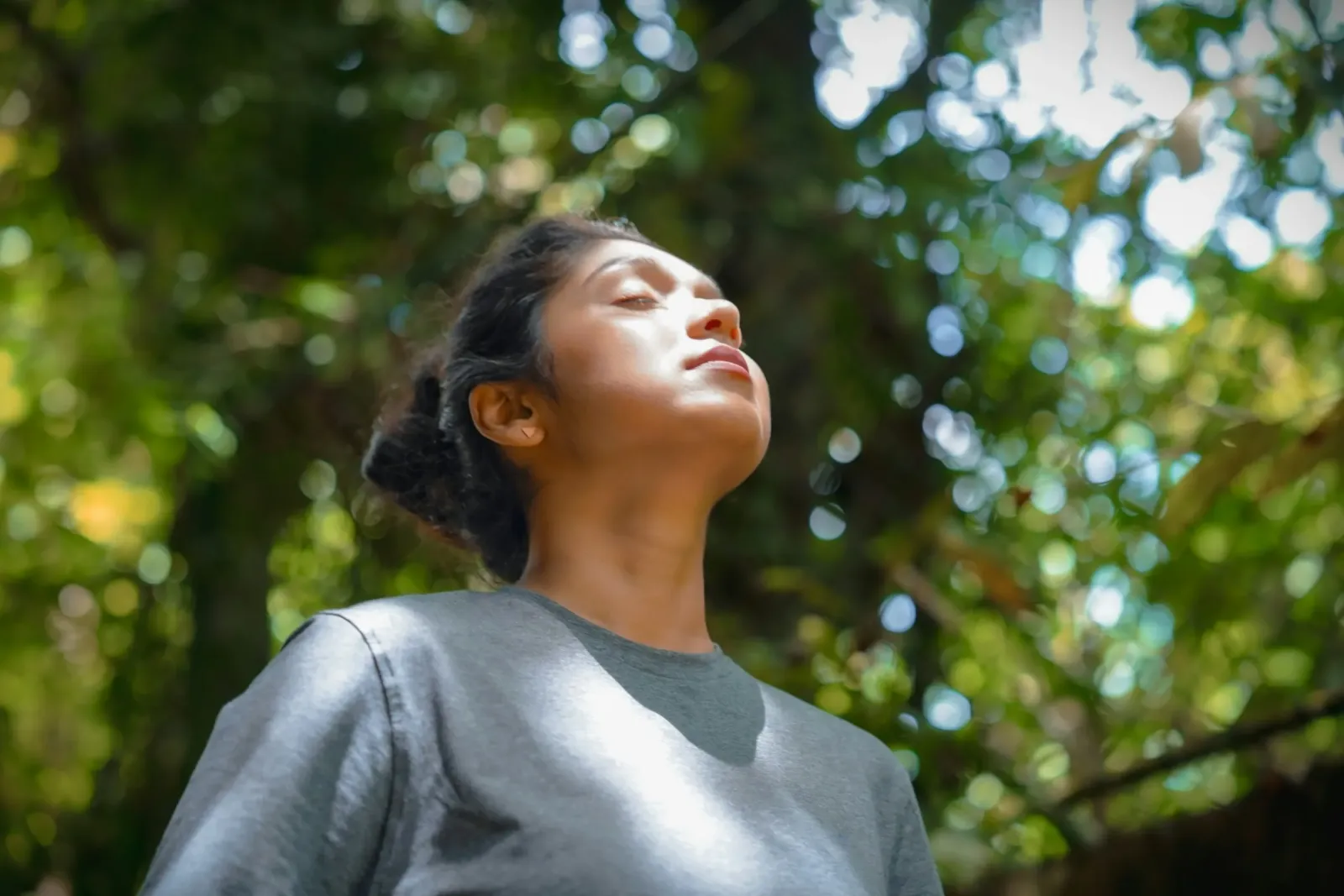 A woman breathing fresh air among trees