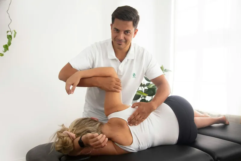 A physiotherapist treating a patient’s shoulder
